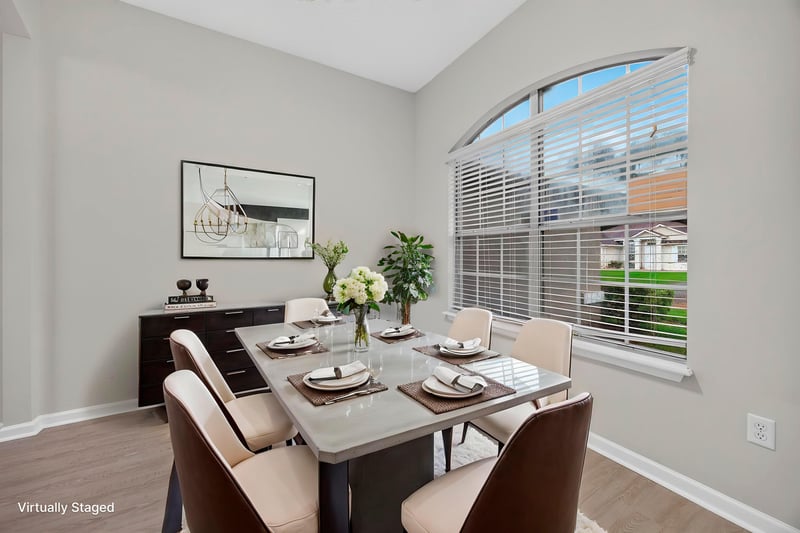 Virtually staged dining room with table set for four at 706 Bonaparte Dr, Jacksonville, FL 32218