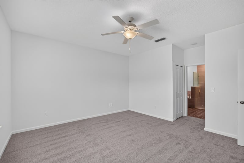 Bedroom with wood-look flooring and doorway at 9905 Ansley Lake Dr, Jacksonville, FL