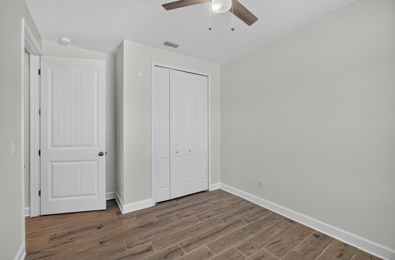 Bedroom with double closet doors at 855 Flach Dr, St. Johns, FL