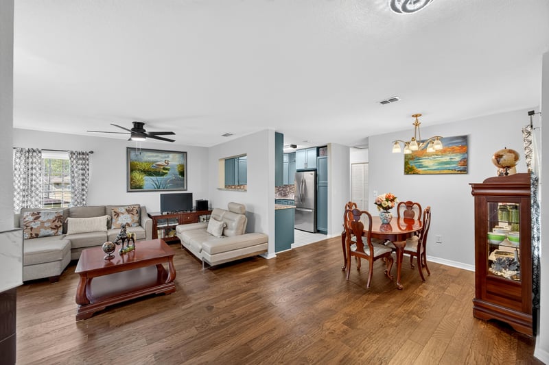 Living and dining area with hardwood floors and sliding glass doors at 10150 Belle Rive Blvd, Jacksonville, FL