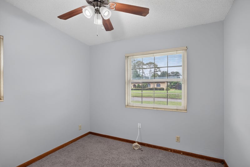 Carpeted bedroom with window at 11462 Elane Dr, Jacksonville, FL