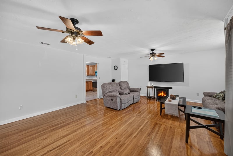 Living room with ceiling fan and mounted TV at 1847 Grove Park Dr, Orange Park, FL