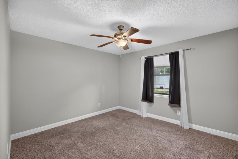 Carpeted bedroom with window at 12344 Cormorant Ct, Jacksonville, FL