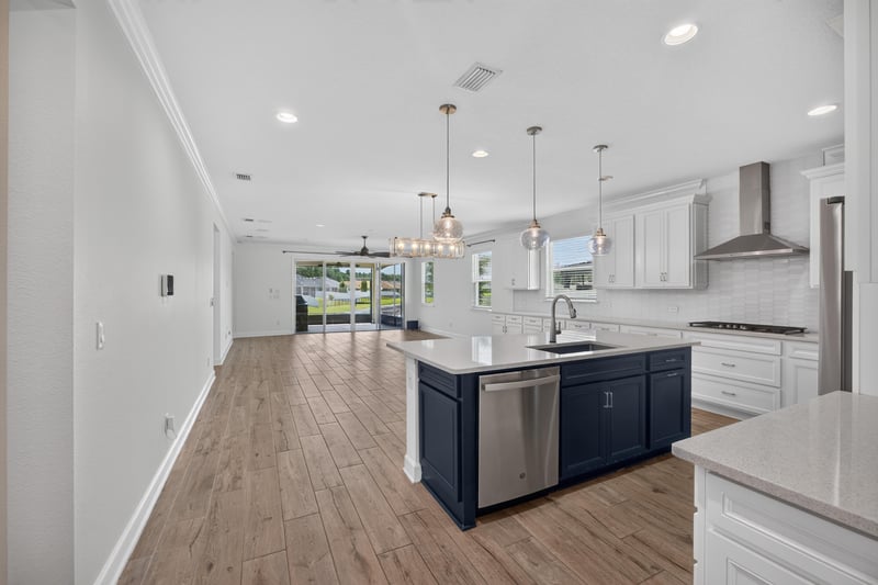 Hallway view toward kitchen with wood floors at 855 Flach Dr, St. Johns, FL
