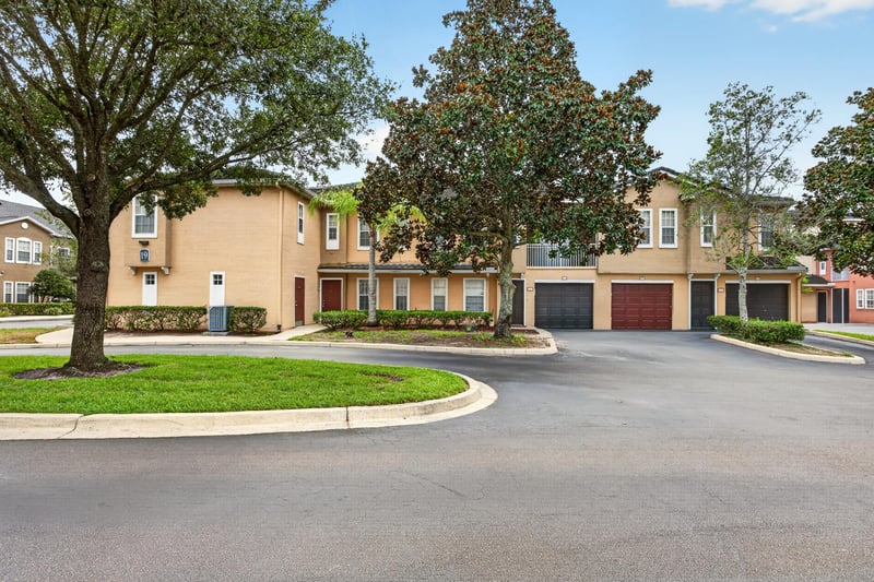 Street view of condo buildings and mature trees at 10075 Gate Pkwy unit 1905, Jacksonville, FL 32246
