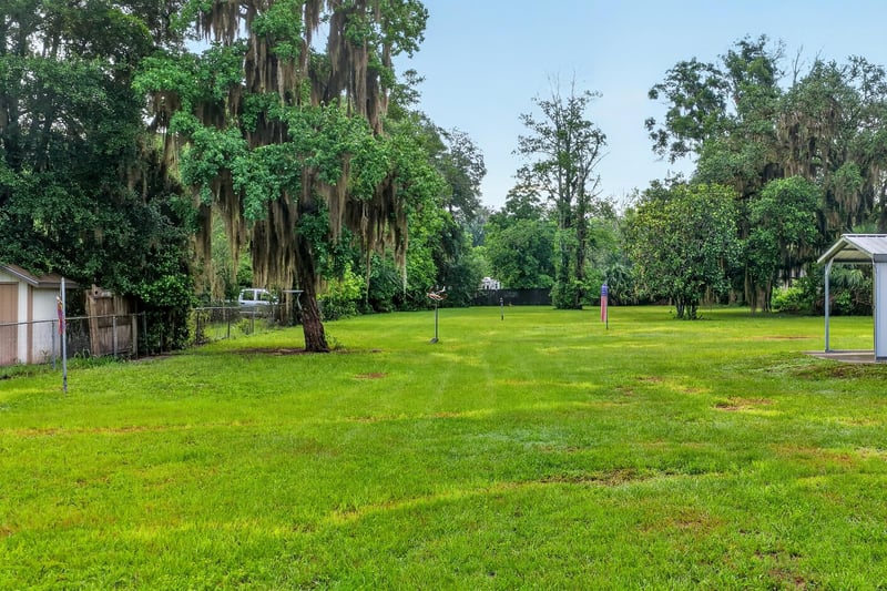 Open lawn area with mature trees at 1619 Hammond Blvd, Jacksonville, FL