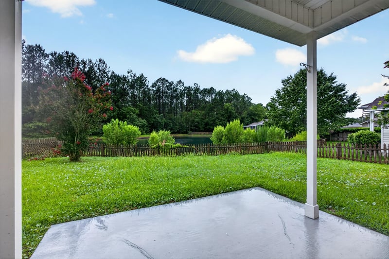 Covered patio with concrete slab and lawn at 706 Bonaparte Dr, Jacksonville, FL 32218