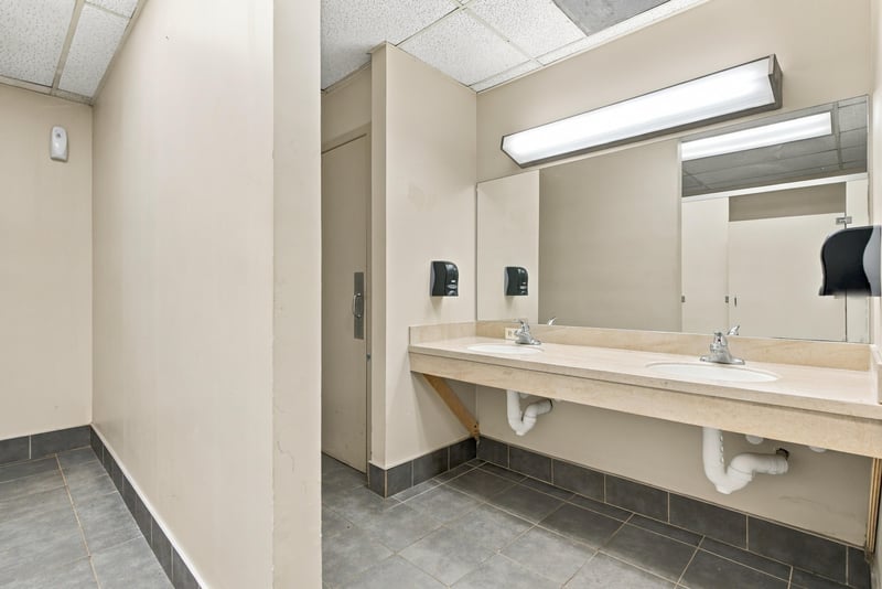 Restroom with long sink vanity and mirror at 101 Scholars Wy