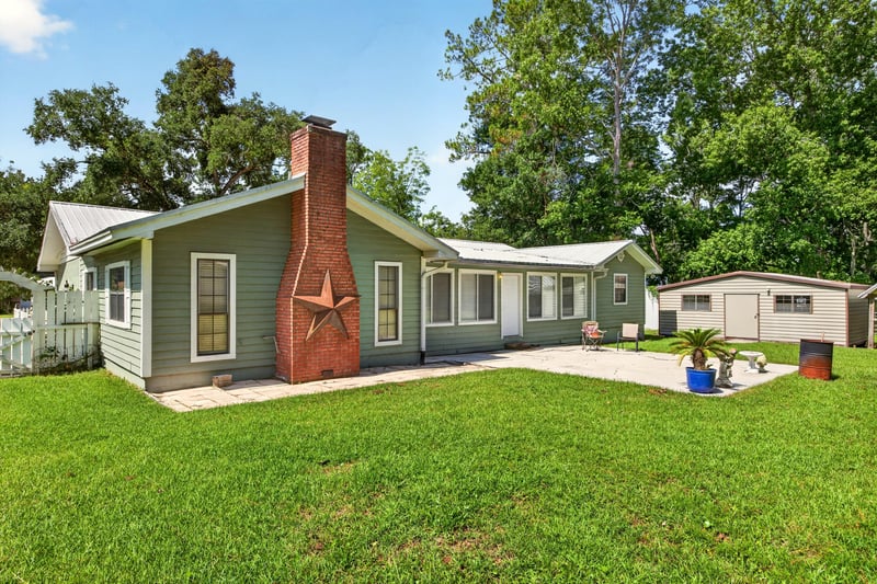 Backyard with brick chimney and patio area at 5843 Ovella Rd, Jacksonville, FL 32244