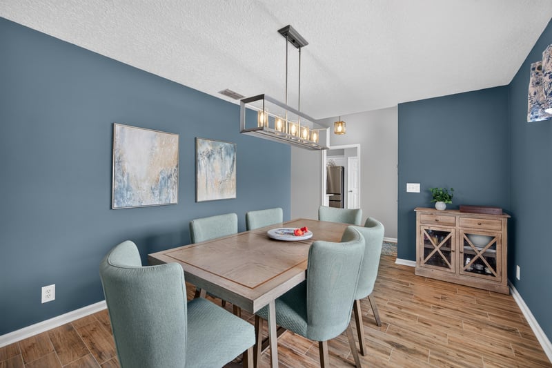 Dining room with pendant light and blue accent walls at 12825 Kelsey Island Dr, Jacksonville, FL 32224
