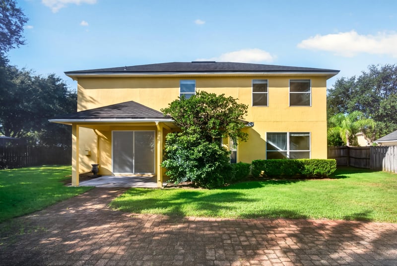 Rear exterior with paver patio and backyard at 470 Sparrow Branch Cir, Jacksonville, FL 32259