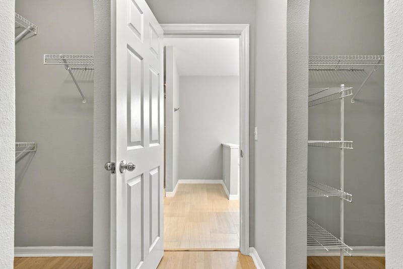 Hallway with wood floors leading to closet at 11197 Illford Dr