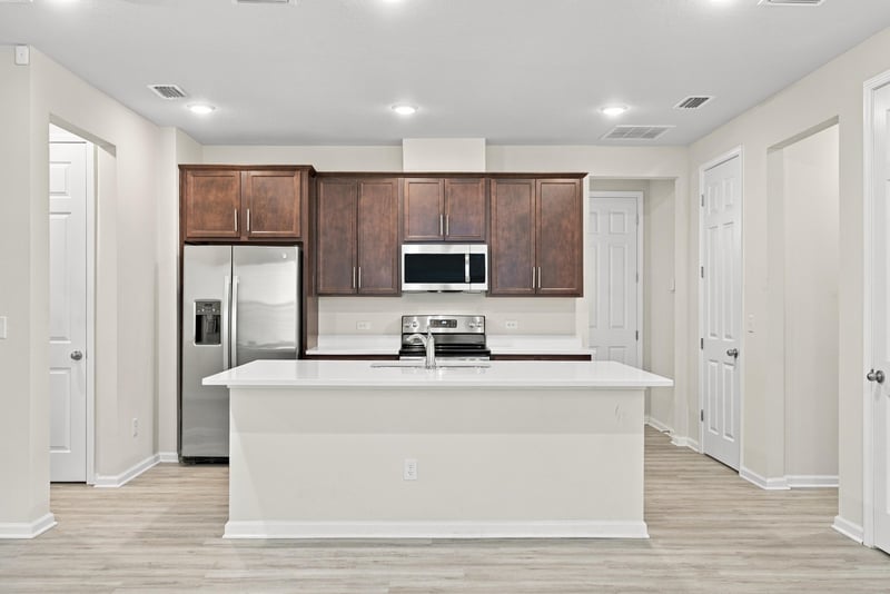 Kitchen with island and stainless refrigerator at 7088 Mahogany Run Dr, Jacksonville, FL 32244