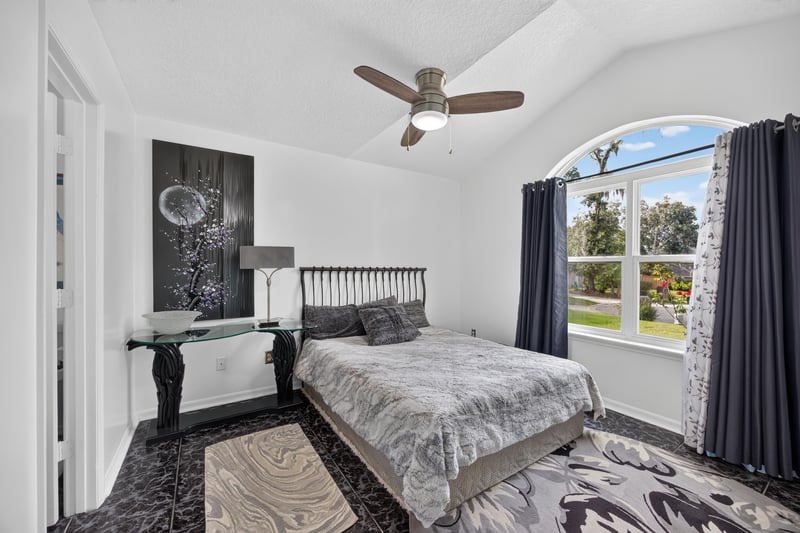 Bedroom with arched window and ceiling fan at 1346 Gately Ct, Jacksonville, FL 32225
