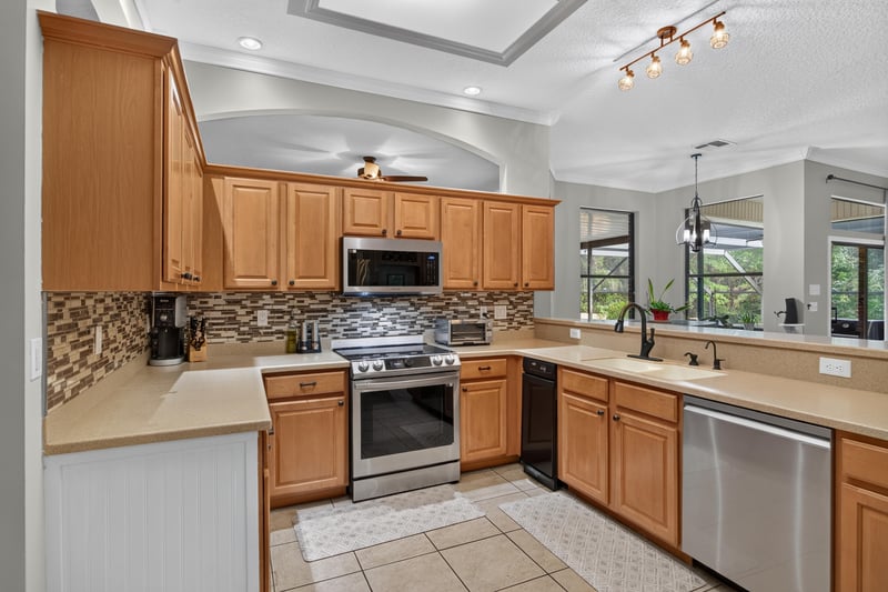 Kitchen with stainless appliances and tile backsplash at 2125 Blue Heron Cove Dr, Orange Park, FL 32003