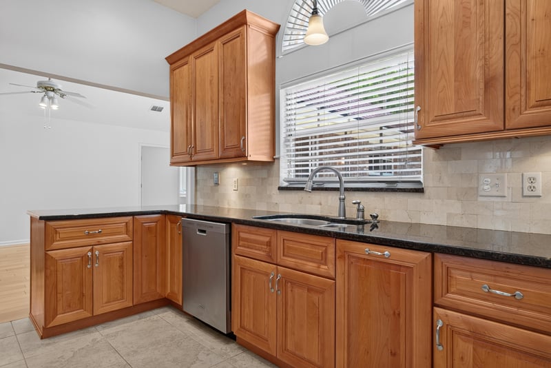 Kitchen sink area with granite counters at 12810 Swamp Owl Ln