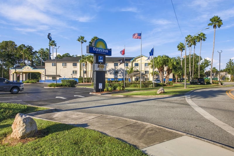 Front exterior with flagpoles, photographed by Megapixeler on Eldridge Loop, Orange Park