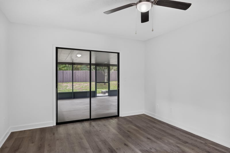 Room with sliding glass door and wood floor at 551 Deltona Blvd, St. Augustine, FL 32086