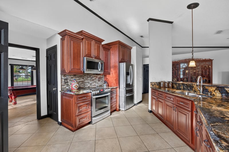 Kitchen with wood cabinets and stainless range at 6931 Cane Grass Ln E, Jacksonville, FL 32244