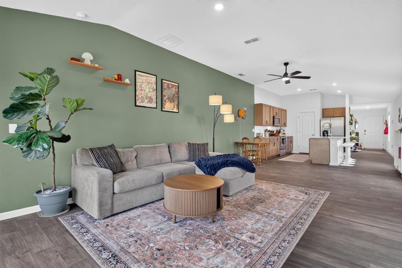 Living room with green accent wall at 4276 Quaking St, Jacksonville, FL 32218