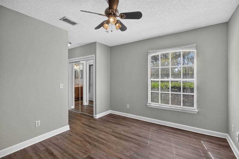 Bedroom with window and hardwood floors at 1701 The Greens Way 1415, Jacksonville Beach, FL 32250