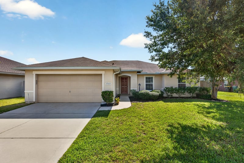Front exterior with two-car garage at 7545 Lirope St, Jacksonville, FL 32244