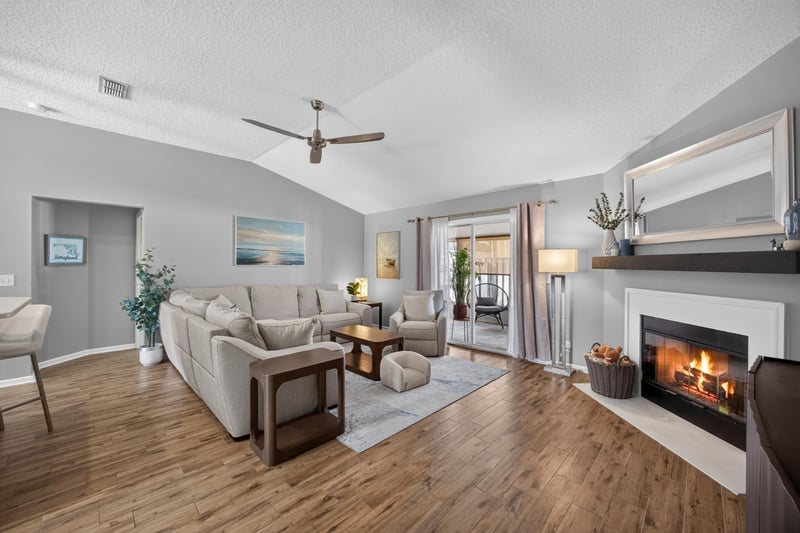 Living room with vaulted ceiling and fireplace at 12825 Kelsey Island Dr, Jacksonville, FL 32224
