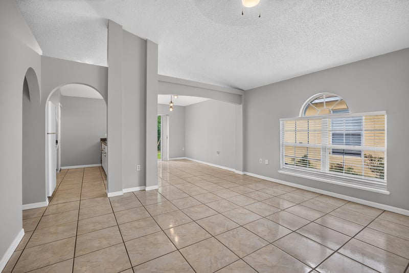 Living room with archway and tile flooring at 7329 Lawn Tennis Ln, Jacksonville, FL