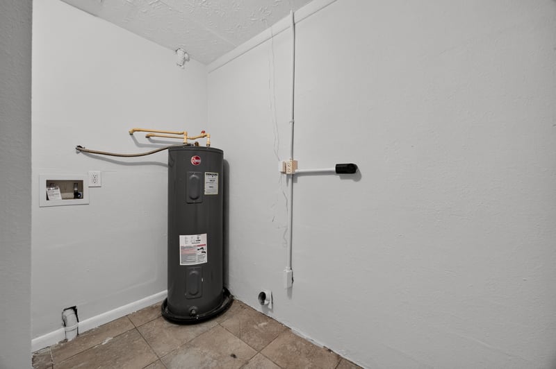 Laundry closet with water heater at 7453 Jade Dr N, Jacksonville, FL 32210
