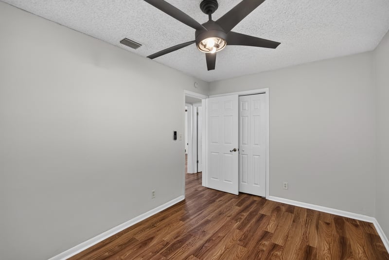 Bedroom with closet doors and wood floor at 4039 Habana Ave, Jacksonville, FL