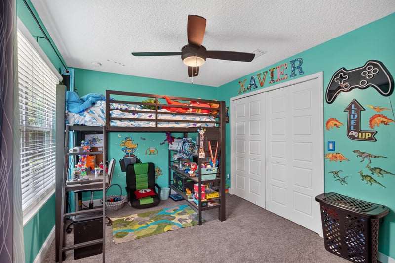 Bedroom with bunk beds and teal walls at 2817 Camel Cir, Middleburg, FL