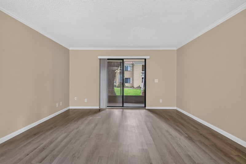 Empty living area with sliding glass door at 5811 Atlantic Blvd unit 47, Jacksonville, FL 32207