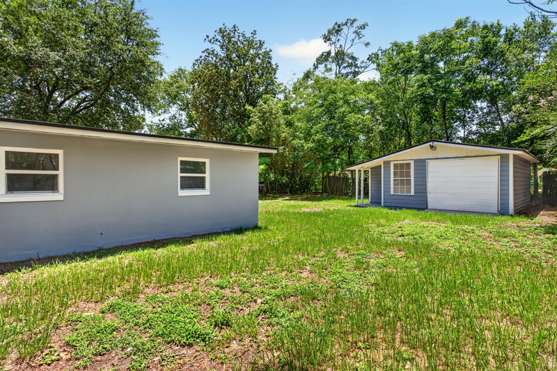 Side yard with trees at 1928 Montmarte Dr, Jacksonville, FL 32210