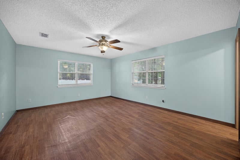 Bedroom with light blue walls and wood floors at 892 Branscomb Rd, Green Cove Springs, FL