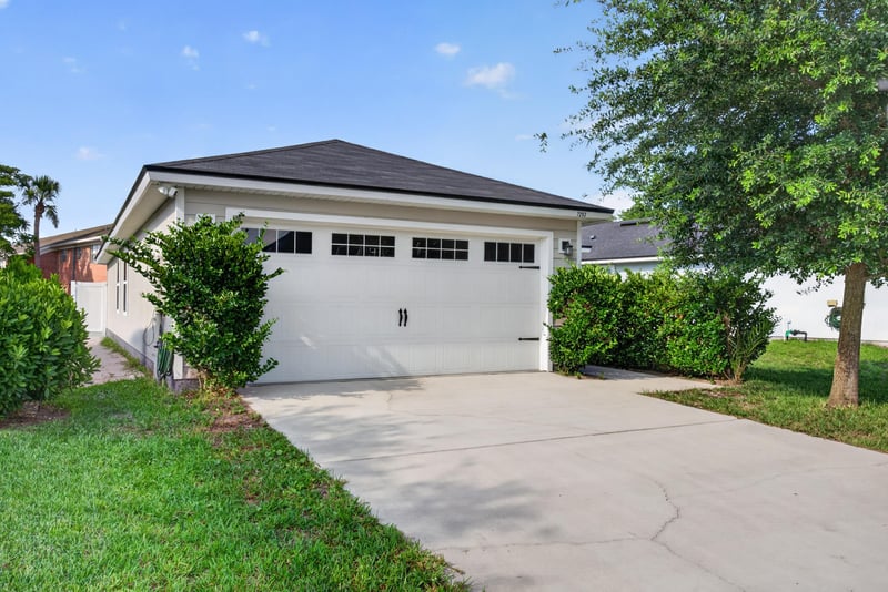 Front exterior straight-on view of garage and driveway at 7253 Townsend Village Ct, Jacksonville, FL