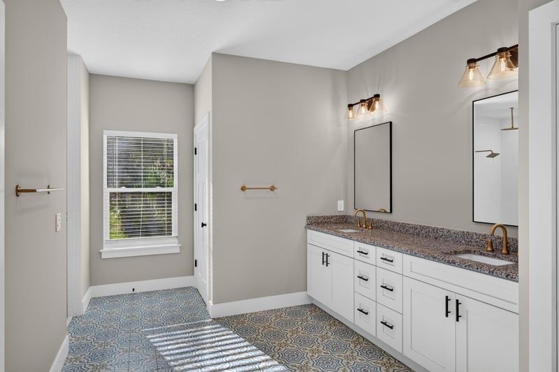 Bathroom with double vanity and granite counters at 175 Alava Ct