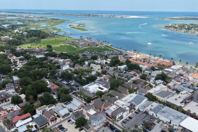 Aerial view of the fort, inlet, and historic district rooftops in St. Augustine, FL