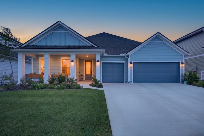 Front exterior at day-to-dusk with covered porch and garage at 2354 Jennings Farm Dr, Middleburg, FL 32068