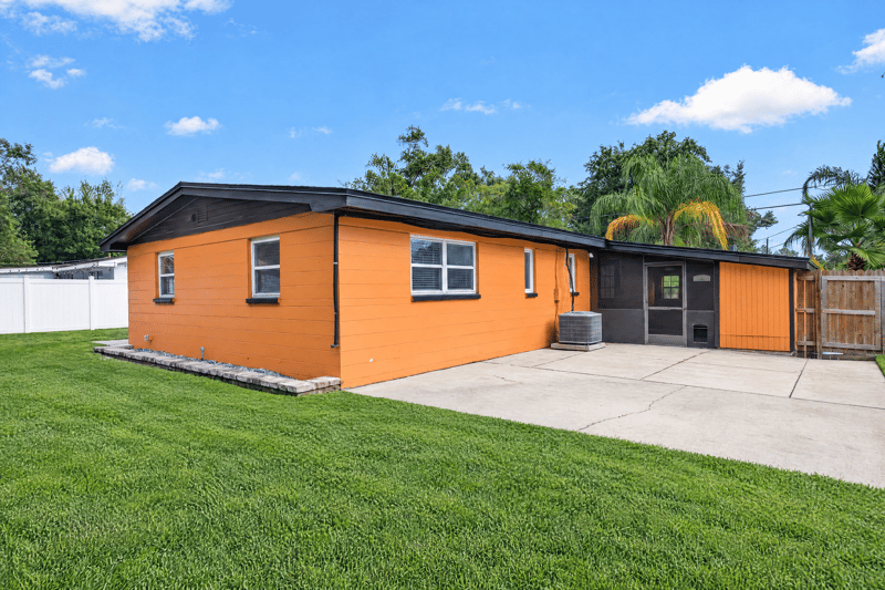 Back exterior with concrete patio and screened porch at 4039 Habana Ave, Jacksonville, FL