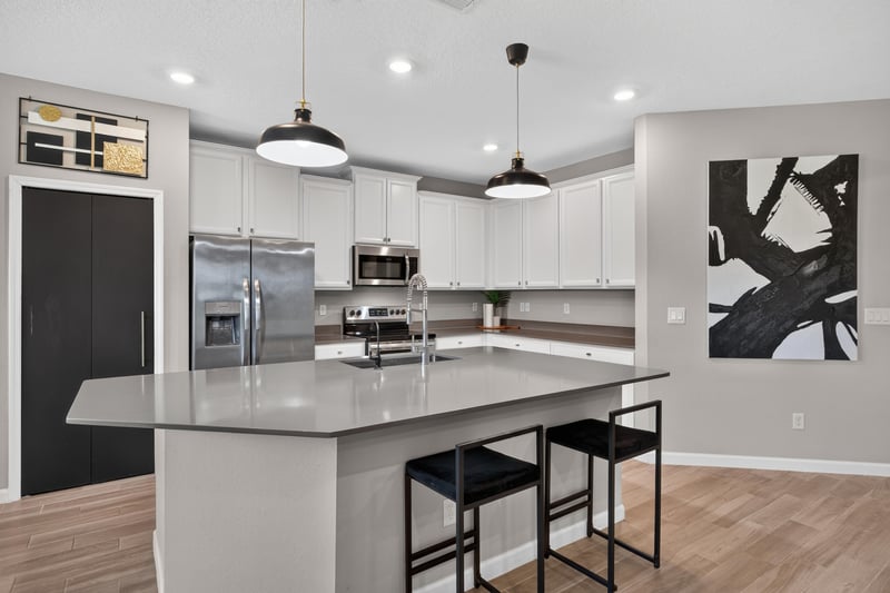 Kitchen island with stainless refrigerator at 9942 Lovage Ln, Jacksonville, FL 32219