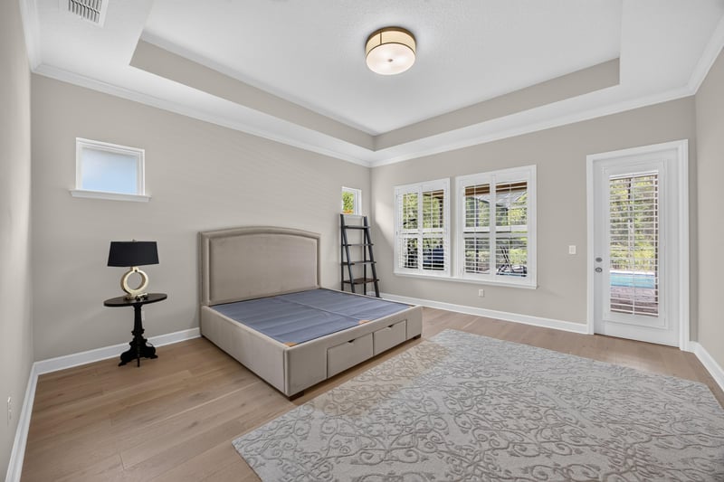 Bedroom with tray ceiling and upholstered bed at 276 Cross Ridge Dr, Ponte Vedra Beach, FL 32081