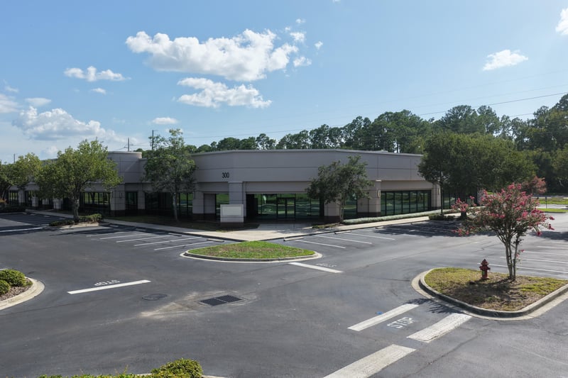 Parking lot with palm trees between buildings at 10550 Deerwood Park Blvd, Jacksonville, FL 32256