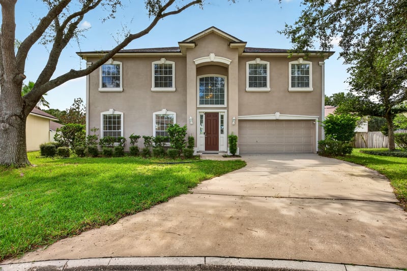 Front exterior view across the lawn at 2875 Pebblewood Ln, Orange Park, FL 32065