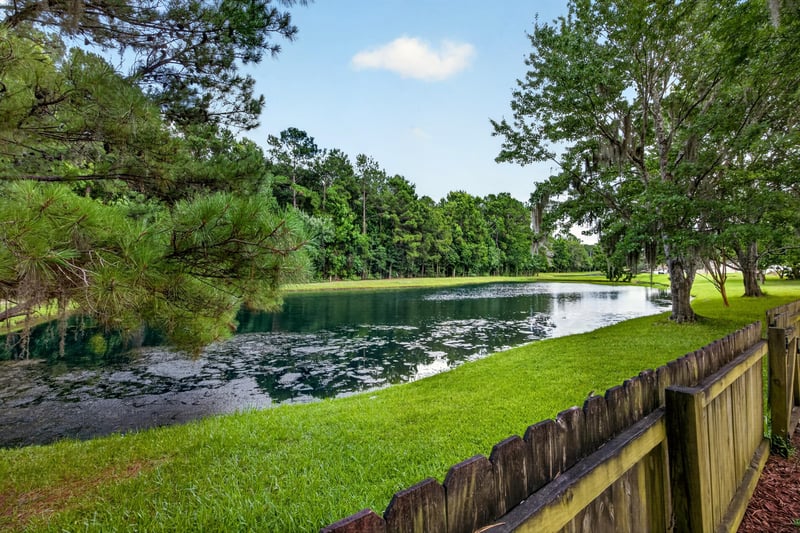 Pond view beyond the backyard fence in Orange Park, FL