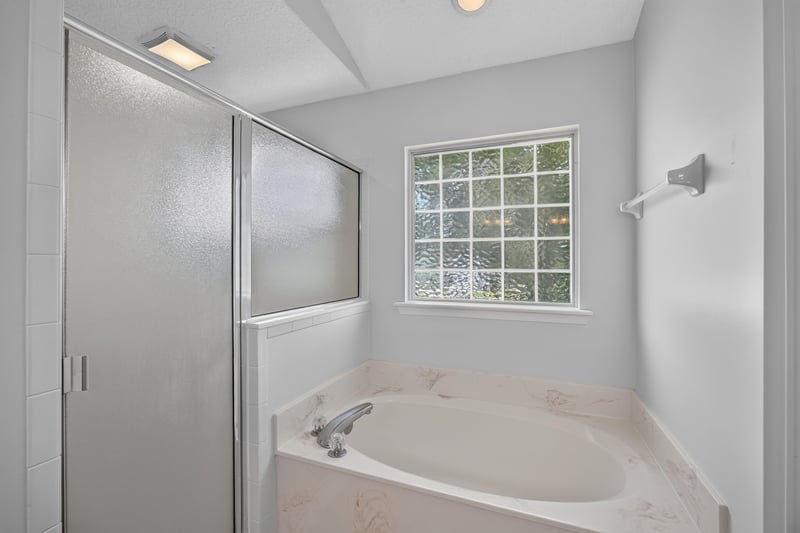 Bathroom with soaking tub and glass-block window at 2480 Ridge Will Dr, Jacksonville, FL 32246