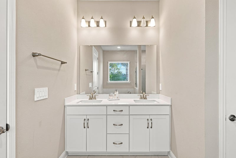 Primary bathroom with double vanity and framed mirror at 27 Holly Rdg Wy, St. Augustine, FL