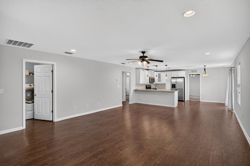 Empty room with wood floors leading to kitchen at 1002 Ingleside Ave, Jacksonville, FL 32205