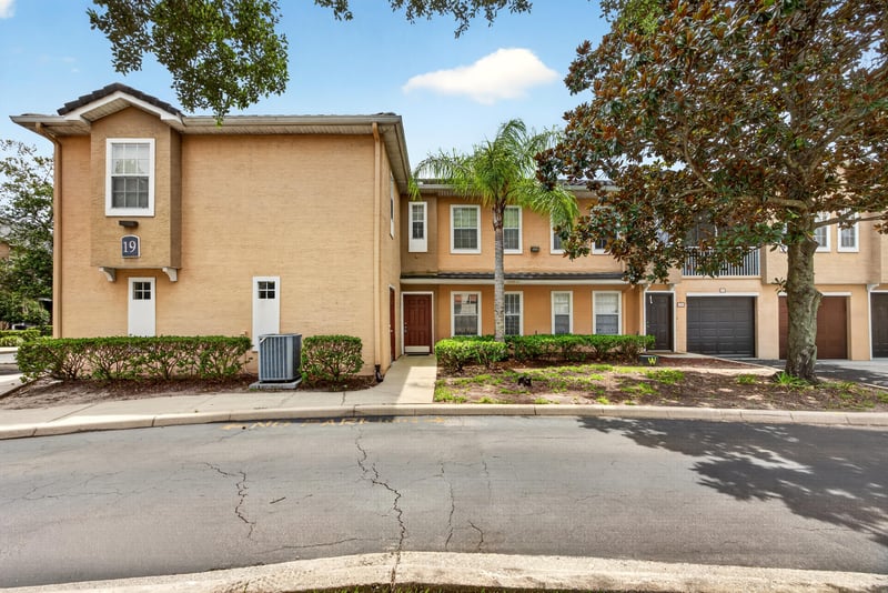 Exterior of the condo building with stairs and garages at 10075 Gate Pkwy unit 1905, Jacksonville, FL 32246