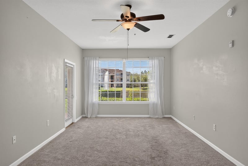 Living room corner with large windows at 7990 Baymeadows Rd E #404, Jacksonville, FL 32256