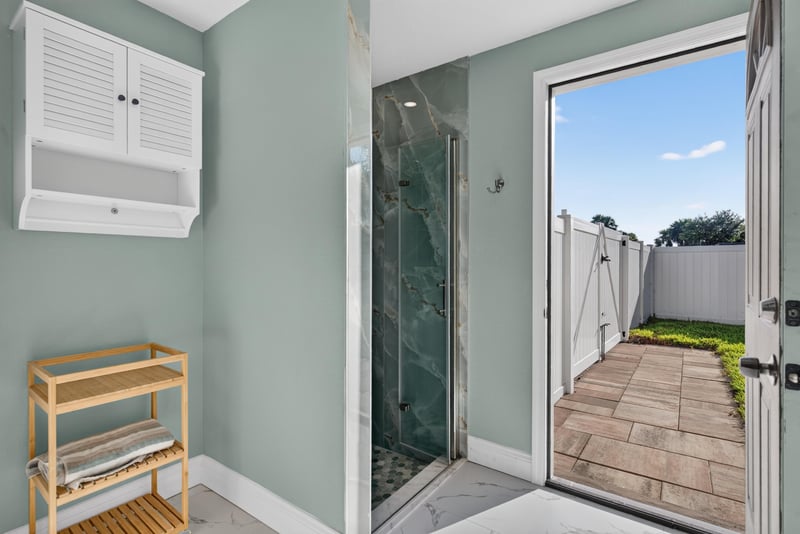 Bathroom with door to outdoor shower at 1525 8th St N, Jacksonville Beach, FL